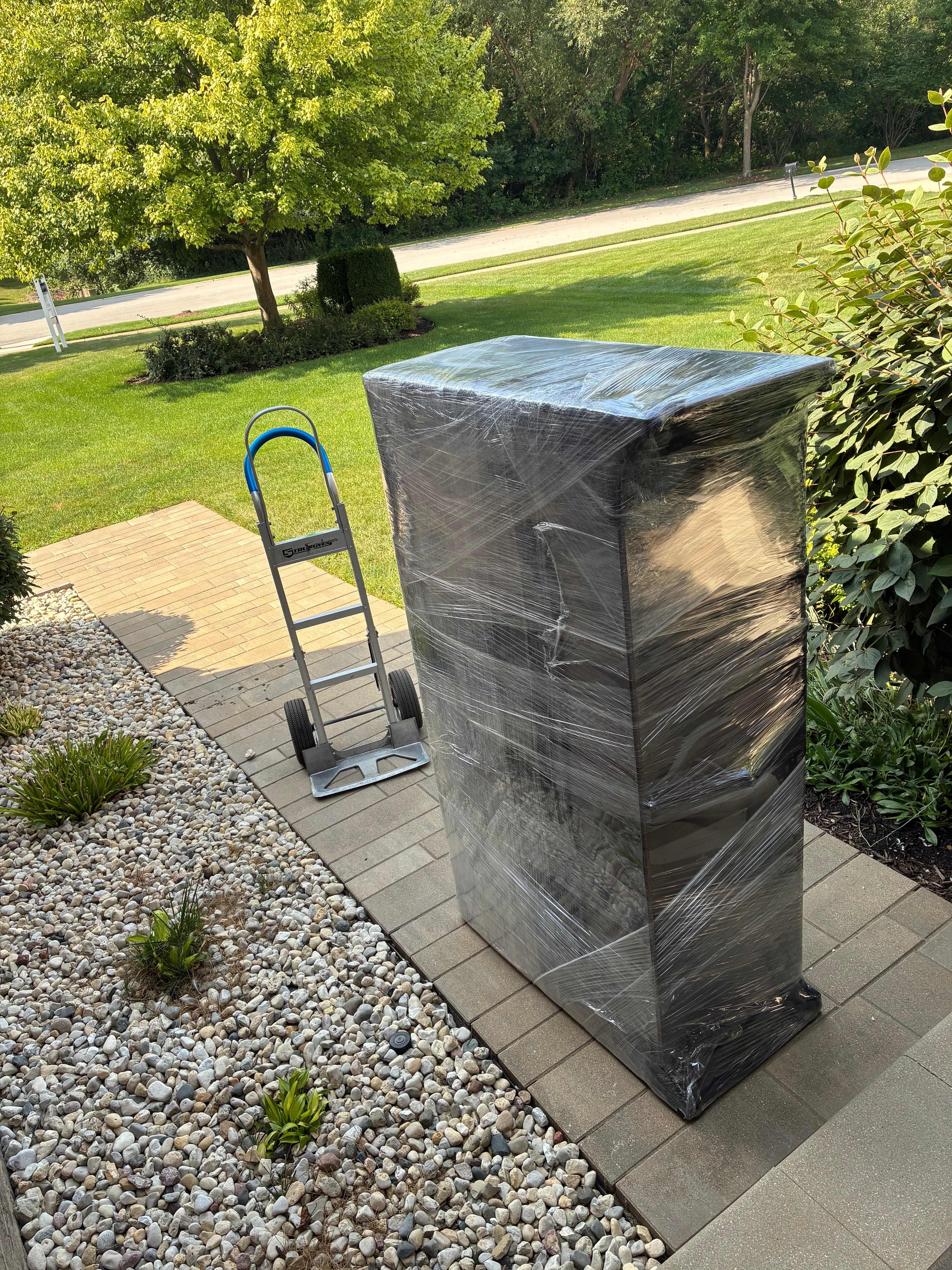 Furniture carefully wrapped and staged on dollies for a residential move